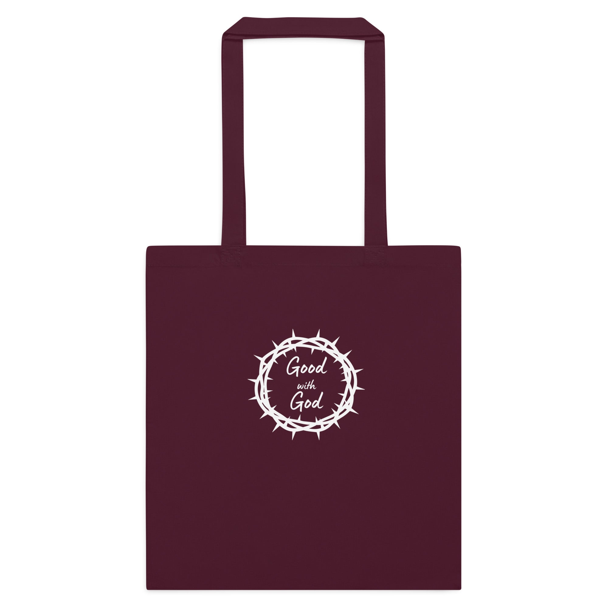 A dark maroon tote bag with two handles, featuring a white graphic in the center of a crown of thorns enclosing the words 'Good with God'.