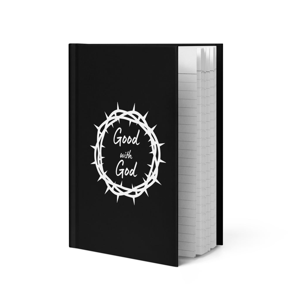 A black hardcover notebook with a white crown of thorns graphic and the words 'Good with God' on the front cover, shown standing upright against a white background.
