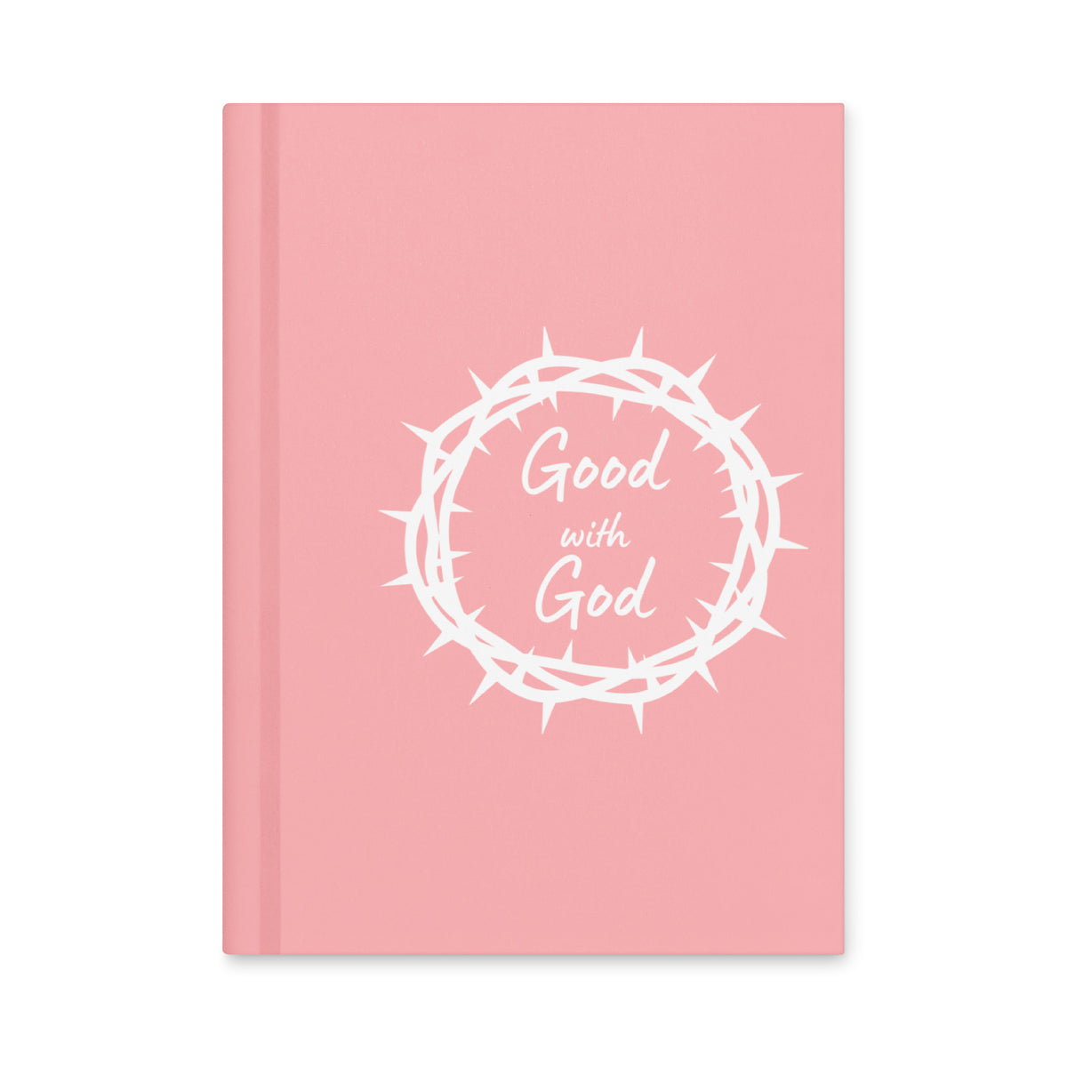 A pink hardcover notebook with a white graphic of a crown of thorns and the words 'Good with God' on the front cover, shown against a plain white background.