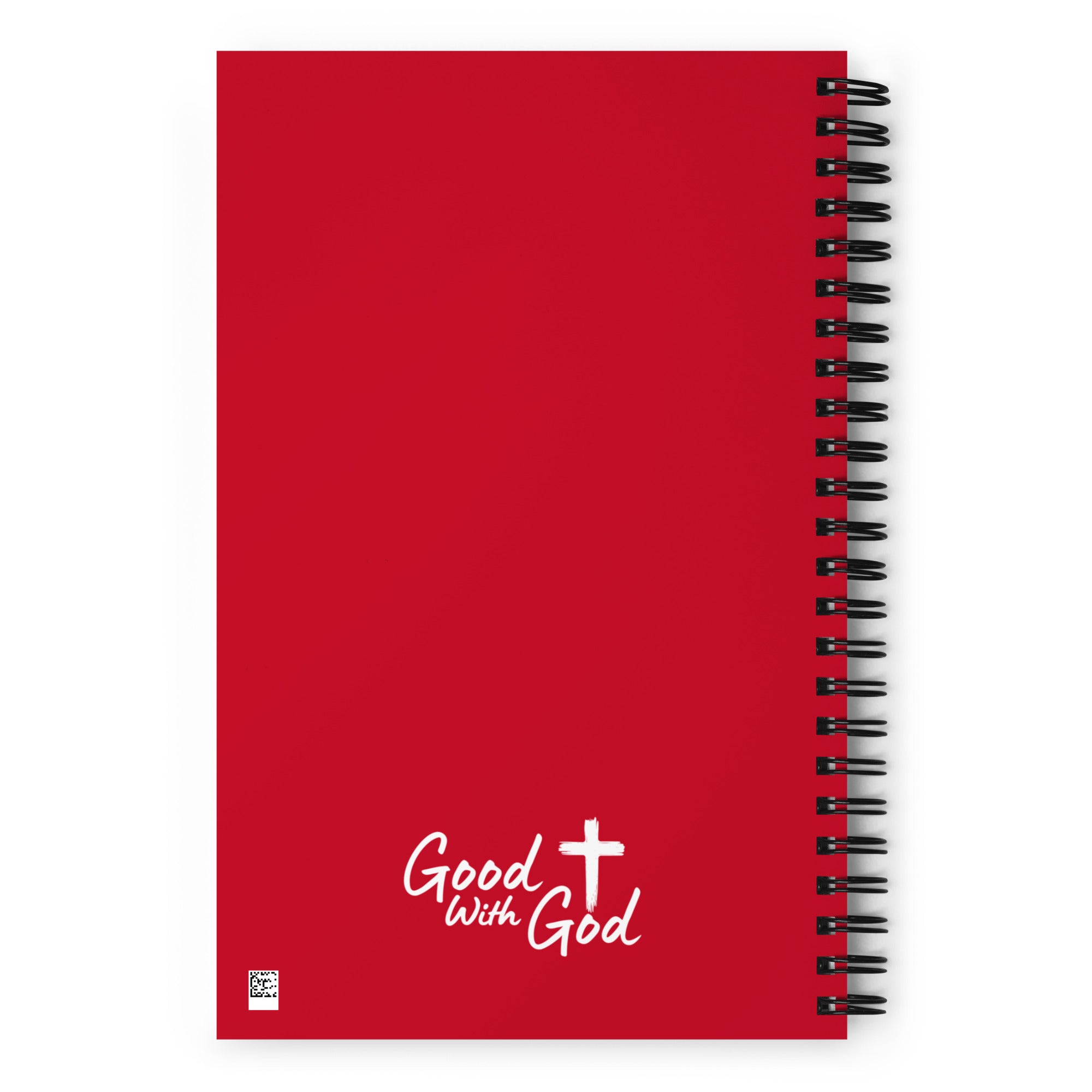 A red spiral-bound notebook with a black wire coil binding and the words 'Good with God' printed in white near the bottom, alongside a white cross graphic.