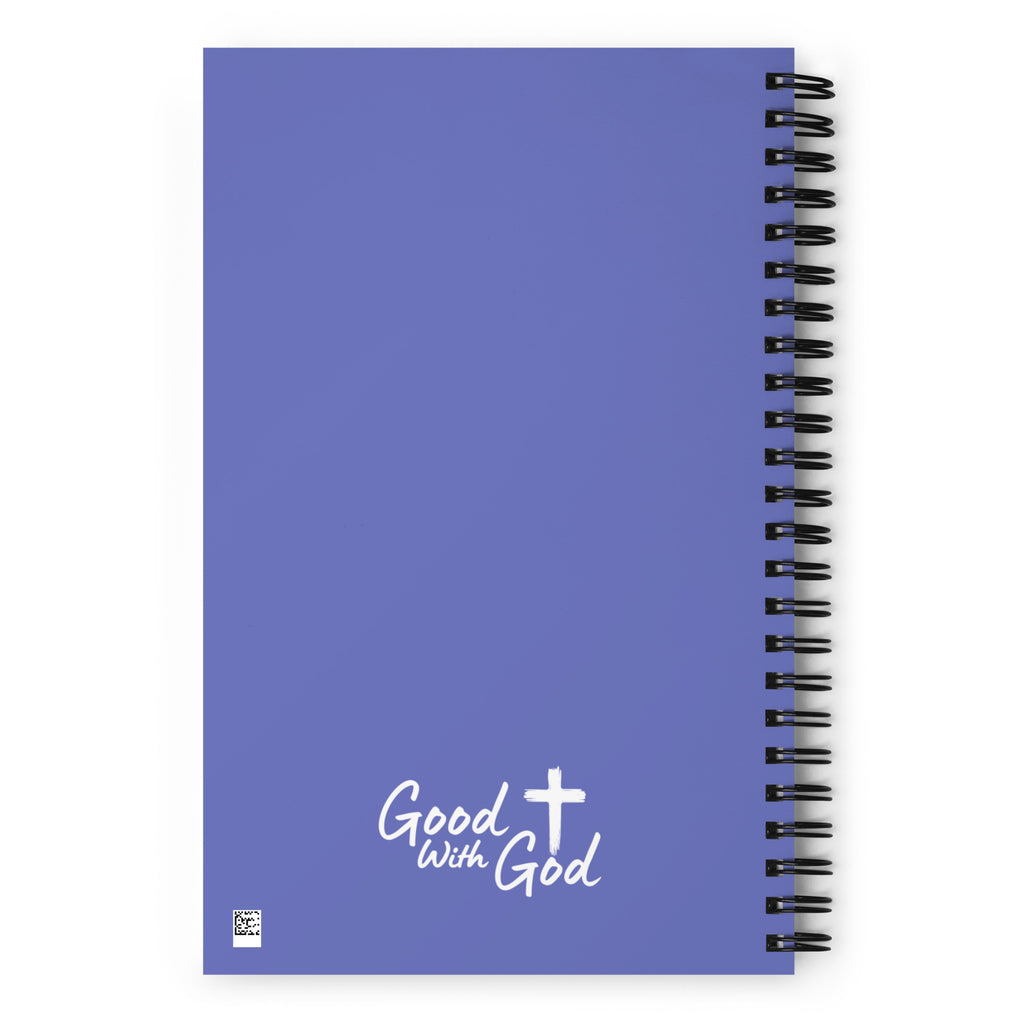 A blue-purple spiral notebook with a black wire binding and the words 'Good with God' printed in white near the bottom, shown on a plain white background.