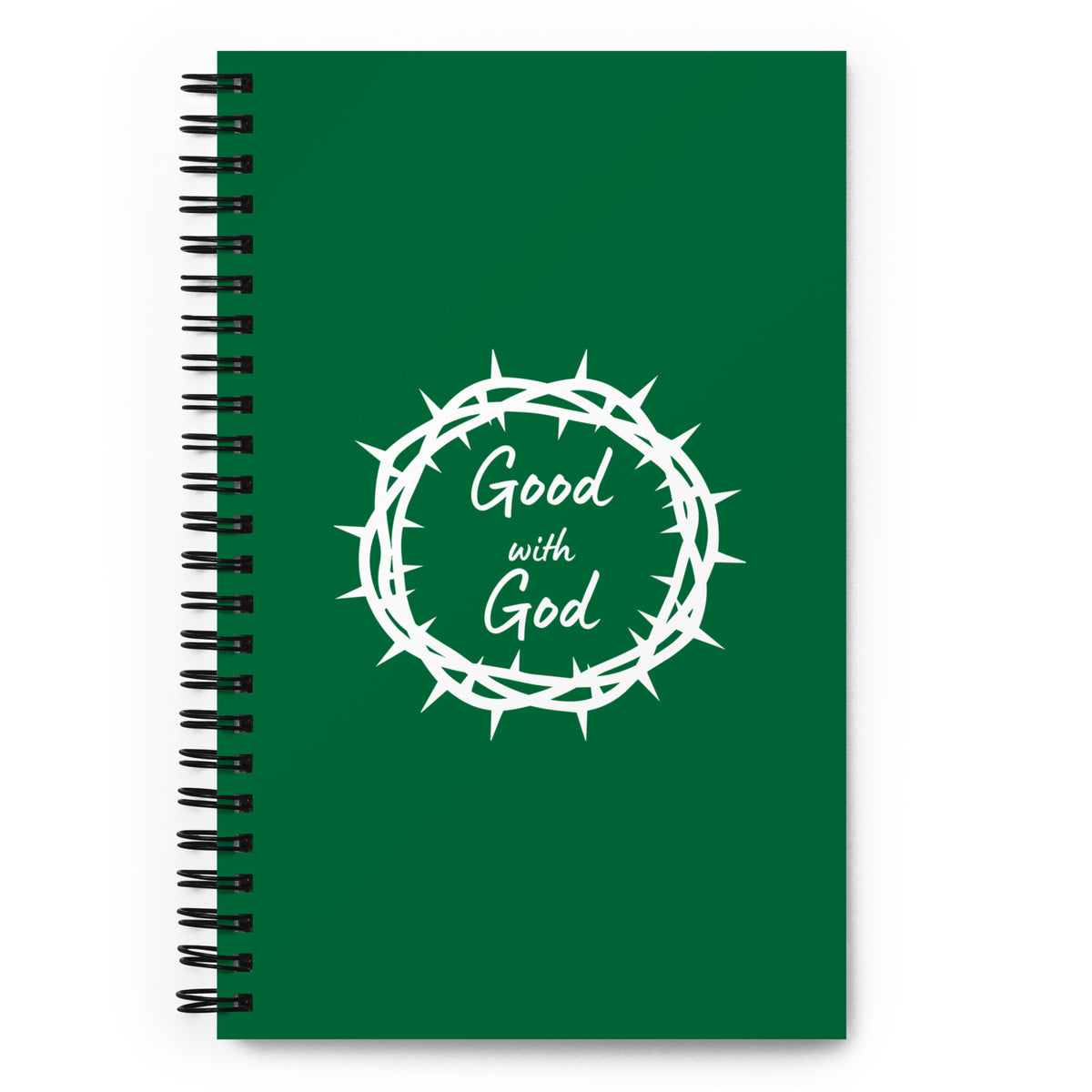 A dark green spiral notebook with a black wire binding and a white graphic of a thorny crown of thorns surrounding the words 'Good with God' in a cursive font, shown on a plain white background.