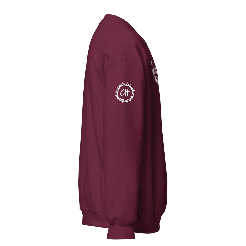 Product Right sleeve detail of maroon Good With God crew neck sweatshirt featuring printed white crown of thorns logo with cross.